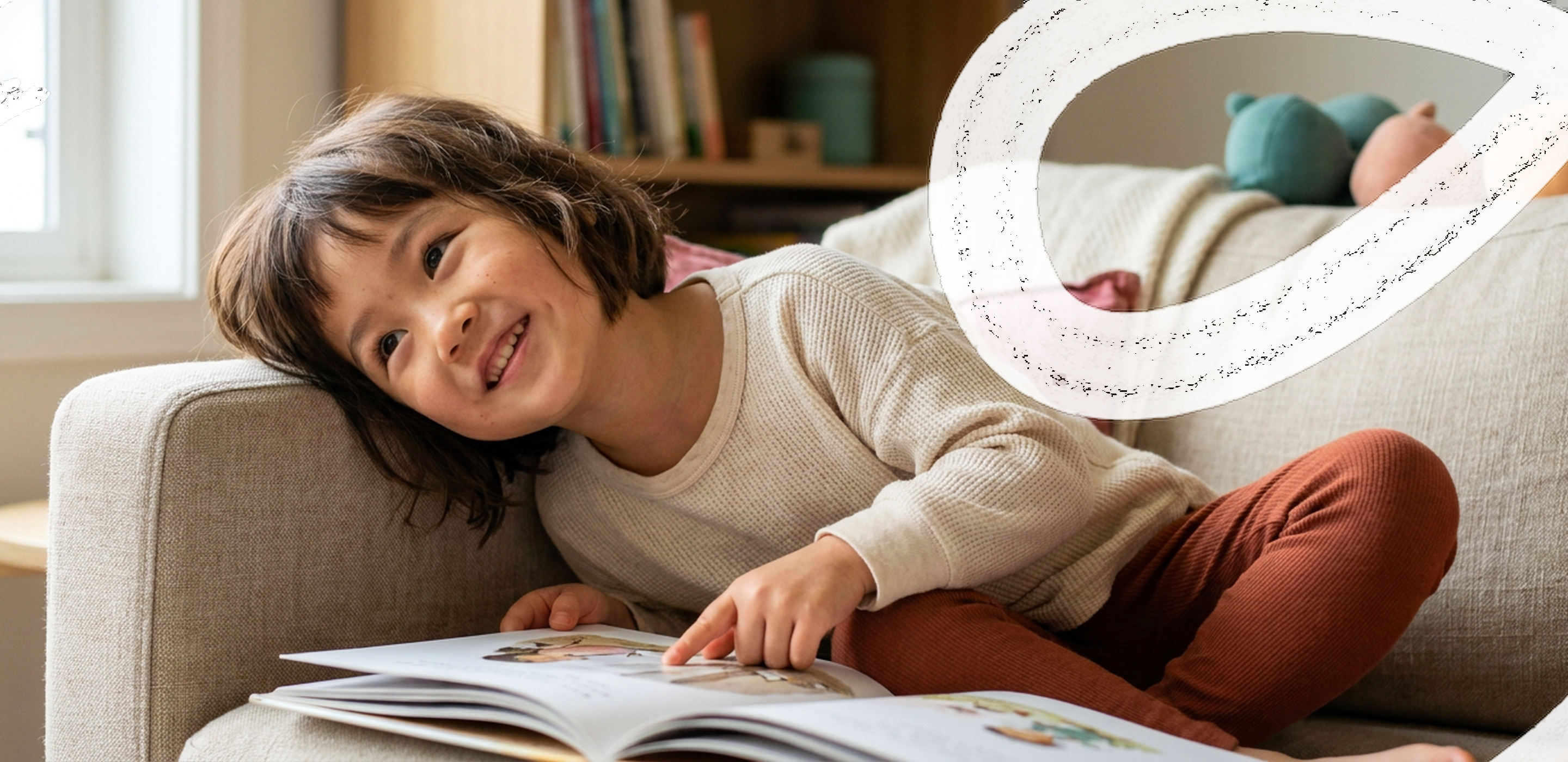 A young girl reading on a couch during a session at ANNA